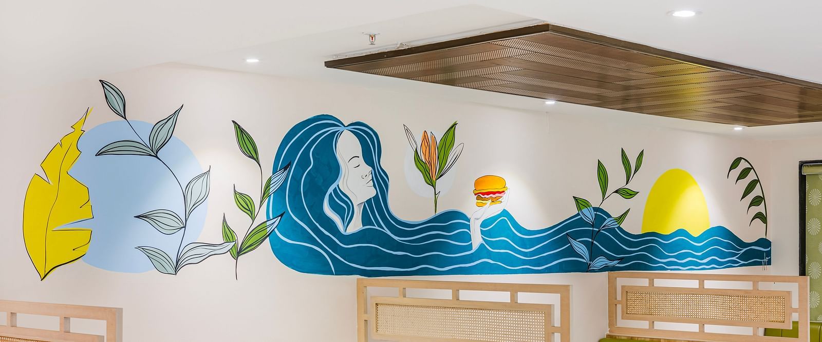 Lemonridge Hotels, KPHB | Close-up of artistic wall decorations in the dining area. Whimsical and colorful designs.